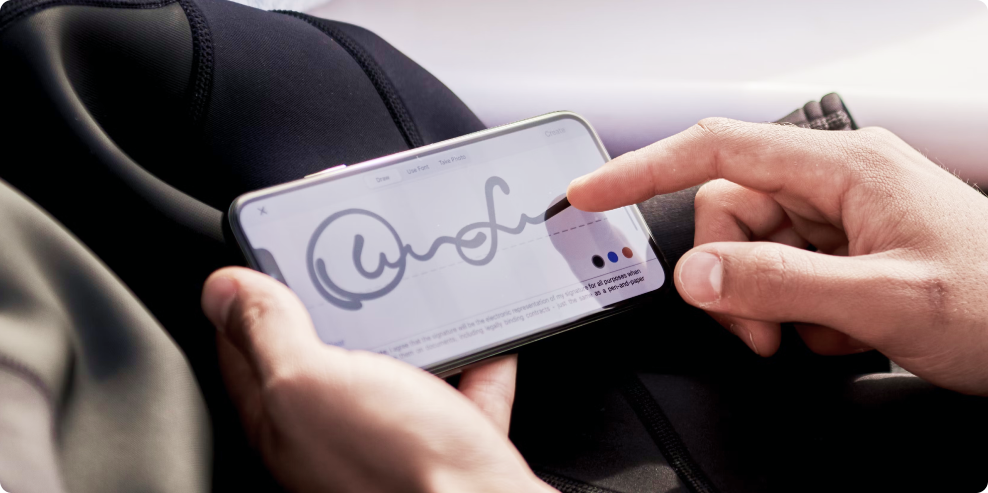 person signing an electronic document on a smartphone screen